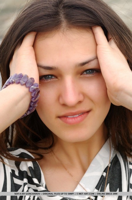 Грудастая детка Sofi A позирует на берегу моря только в сеточке